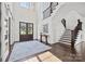 Bright foyer with hardwood floors, staircase, and modern decor provides a grand entrance at 1976 Ferncliff Rd, Charlotte, NC 28211