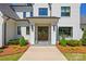 Elegant home entrance featuring double doors, sconces, and well-maintained landscaping at 1976 Ferncliff Rd, Charlotte, NC 28211