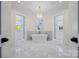 Luxurious main bathroom featuring freestanding tub, marble flooring, and dual vanities at 1976 Ferncliff Rd, Charlotte, NC 28211