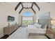 Spacious main bedroom with vaulted ceiling, chandelier, and expansive windows at 1976 Ferncliff Rd, Charlotte, NC 28211