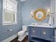 Chic powder room with patterned wallpaper, elegant gold mirror, and stylish vanity at 1976 Ferncliff Rd, Charlotte, NC 28211