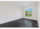 Versatile room with natural light, black flooring, and a view of the landscape at 1976 Ferncliff Rd, Charlotte, NC 28211