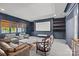 Cozy theater room with a large screen, built-in shelving, comfortable seating, and neutral decor at 1976 Ferncliff Rd, Charlotte, NC 28211