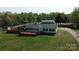 Expansive aerial view of the home and property featuring a fence line, storage building and a long driveway at 2055 Cauble Rd, Salisbury, NC 28144