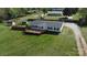 Drone view of the home showcasing the front yard, deck, outbuilding, and fence line at 2055 Cauble Rd, Salisbury, NC 28144