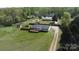 Wide angle aerial view of the home and property with mature trees, green grass and an outbuilding at 2055 Cauble Rd, Salisbury, NC 28144