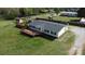 Overhead view of the home with a deck, fenced in yard and driveway situated on a grassy lot at 2055 Cauble Rd, Salisbury, NC 28144