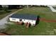 Aerial view of a home's backyard featuring a fenced yard, patio, and ample green space at 2055 Cauble Rd, Salisbury, NC 28144