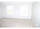Clean bedroom with carpeted flooring and two sunny windows, offering a comfortable living space at 2055 Cauble Rd, Salisbury, NC 28144