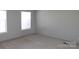 This is a bedroom with neutral carpet and walls, illuminated by natural light from two windows at 2055 Cauble Rd, Salisbury, NC 28144