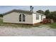 Siding accentuates the home’s exterior, complemented by a stone foundation and groomed surroundings at 2055 Cauble Rd, Salisbury, NC 28144