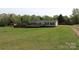 Exterior view showcases home with well-maintained yard and a scenic landscape at 2055 Cauble Rd, Salisbury, NC 28144