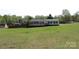 Landscaped lawn surrounds this home with its generous green space and tree-lined backdrop at 2055 Cauble Rd, Salisbury, NC 28144