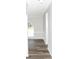 Well-lit hallway with wood-look flooring, leading to rooms with abundant natural light through the arched window at 2055 Cauble Rd, Salisbury, NC 28144