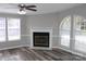 Bright living room with a fireplace, ceiling fan and an arch window offering plenty of natural light at 2055 Cauble Rd, Salisbury, NC 28144