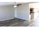 Bright living room with a ceiling fan and new flooring, flowing into an open kitchen area at 2055 Cauble Rd, Salisbury, NC 28144
