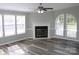Cozy living room with a fireplace, large windows, and stylish flooring at 2055 Cauble Rd, Salisbury, NC 28144
