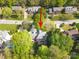 An aerial view of a home with a backyard pool surrounded by lush trees in a tranquil neighborhood at 210 35Th Ne Ave, Hickory, NC 28601