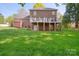 A classic two-story brick home with a walk-out basement and a deck in a verdant backyard at 210 35Th Ne Ave, Hickory, NC 28601