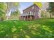 A lovely two-story brick home is set in a verdant backyard with a walk-out basement and deck at 210 35Th Ne Ave, Hickory, NC 28601