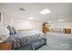 Finished basement area with carpet, bed, sofa, and bright lighting at 210 35Th Ne Ave, Hickory, NC 28601