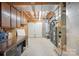 Spacious basement featuring a workbench, utility systems, and convenient access to the outside at 210 35Th Ne Ave, Hickory, NC 28601