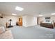 Wide shot of the finished basement area with carpet, desk, exercise bike and bed at 210 35Th Ne Ave, Hickory, NC 28601