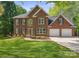 Traditional brick home with a two-car garage and manicured lawn featuring new landscaping at 210 35Th Ne Ave, Hickory, NC 28601