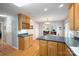Open kitchen with wooden floors, cabinets and breakfast nook leading to living areas at 210 35Th Ne Ave, Hickory, NC 28601