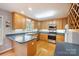 Well-lit kitchen featuring wooden cabinets, modern appliances, and a breakfast bar for casual dining at 210 35Th Ne Ave, Hickory, NC 28601