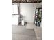 The unfinished laundry room area has a washer, dryer, and shelving at 210 35Th Ne Ave, Hickory, NC 28601