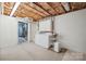 The unfinished laundry room area has a washer, dryer, and shelves at 210 35Th Ne Ave, Hickory, NC 28601