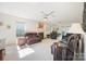 Bright living room with plush carpeting, a fireplace, ceiling fans, and large windows at 210 35Th Ne Ave, Hickory, NC 28601