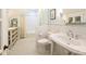 Bright bathroom features a pedestal sink and walk-in shower near a window at 2101 Dilworth W Rd, Charlotte, NC 28203