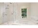 Bright bathroom features a large glass shower and separate soaking tub near a window at 2101 Dilworth W Rd, Charlotte, NC 28203