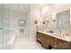 Luxurious bathroom with double vanity, stone counters, tiled floors, and a glass-enclosed shower at 2101 Dilworth W Rd, Charlotte, NC 28203