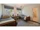 Bedroom with twin beds, charming textiles, large windows, and natural light at 2101 Dilworth W Rd, Charlotte, NC 28203