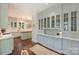 Eat-in kitchen and breakfast nook featuring custom cabinets, marble counters, and hardwood floors at 2101 Dilworth W Rd, Charlotte, NC 28203