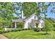 Charming white home featuring a chimney, a screened in porch, and a well-manicured lawn at 2101 Dilworth W Rd, Charlotte, NC 28203