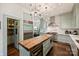 Bright kitchen with a butcher block island, stainless steel appliances, and a walk-in pantry provides ample storage at 2101 Dilworth W Rd, Charlotte, NC 28203