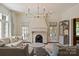 Elegant living room with fireplace, chandelier, and neutral decor offers a comfortable and stylish space at 2101 Dilworth W Rd, Charlotte, NC 28203