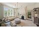 Bright living room with a fireplace, large windows, and ample seating showcases a sophisticated design at 2101 Dilworth W Rd, Charlotte, NC 28203