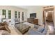 Well-lit living room with doors to the backyard, hardwood floors, and a stylish media cabinet at 2101 Dilworth W Rd, Charlotte, NC 28203