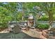 Outdoor entertaining space with fireplace, grill, dining area, and comfortable seating at 2101 Dilworth W Rd, Charlotte, NC 28203