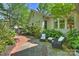 Charming outdoor patio with stone and brick accents, surrounded by lush landscaping at 2101 Dilworth W Rd, Charlotte, NC 28203