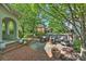 Inviting patio area with outdoor kitchen, fireplace, dining, and comfortable seating at 2101 Dilworth W Rd, Charlotte, NC 28203