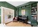 Stylish room featuring a piano, built-in bookshelves, and elegant décor at 2101 Dilworth W Rd, Charlotte, NC 28203