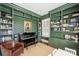 Comfortable room with a piano, custom shelving, and a cozy chair at 2101 Dilworth W Rd, Charlotte, NC 28203