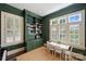 Charming room with built-in bookshelves, a table set, and natural light from shuttered windows at 2101 Dilworth W Rd, Charlotte, NC 28203