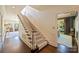 Classic staircase with wood railing, carpeted steps, and white trim leads to the upper level of the home at 2101 Dilworth W Rd, Charlotte, NC 28203